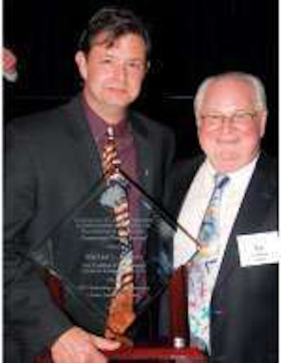 Michael Jeffress (left) poses with the CCJ Career Leadership Award with Ken McKibben, a former award recipient, at the TMC annual meeting.