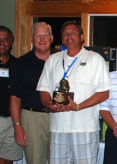 John Minor, Midwest Wheel executive vice president and COO (left), awards Mark Barlage with the 19th annual Don Shoemaker/Scott Wilson Sales Professional of the Year Award.