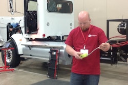 Adam Hillard works with a device that tests for natural gas leaks.