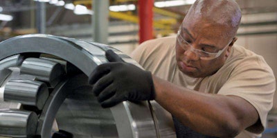 Timken associate Patrick Garner inspects a spherical roller bearing.
