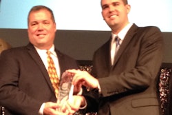 Truck Parts & Service Editor Lucas Deal (right) presents the Distributor of the Year award to Ed Neeley, owner of Truck Supply Co. of South Carolina.