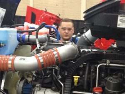 Brian Smith, a technician with Rush Enterprises, gets eye-level in his work.