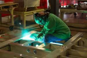 Employee welding at a plant facility