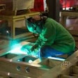 Employee welding at a plant facility