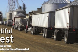 Trucks parked near farm silos
