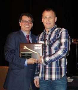 Jerry Kocan, Four Star Freightliner dealer principal (left), presents Kenneth Woodruff with the Technician of the Year award.