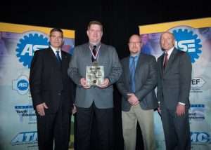 (From left to right) Jeff Walker, chairman of the ASE Board of Directors; Brian Stevens, award winner; Mike Mallett, training programs manager for Freightliner/Western Star; and Tim Zilke, ASE president and CEO