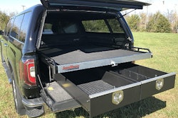 Truck with in-bed sliding tray cargo management systems