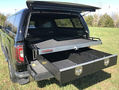 Truck with in-bed sliding tray cargo management systems