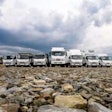 Seven Isuzu commercial trucks parked