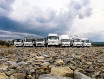 Seven Isuzu commercial trucks parked