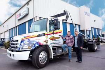 Nick Cipas, founding partner of J. Cipas Container Service (on left) and Henry Knabe Jr., president of H.K. Truck Center