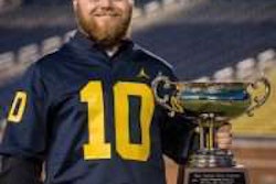 H.K. Truck Center technician Tracey Gennusa poses with his trophy after winning the tenth annual Hino Master Elite Service Skills Competition.