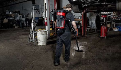 Diesel shop tech using an M18 FUEL 3-in-1 Backpack Vacuum