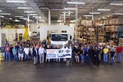 Employees celebrating the 50,000th gasoline-powered Isuzu N-Series truck