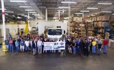 Employees celebrating the 50,000th gasoline-powered Isuzu N-Series truck