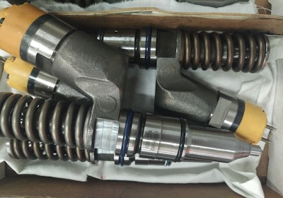 Remanufactured injectors with Diesel Parts of America markings evident on the component.