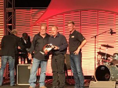 Steven Brain, a medium-duty technician at Rush Truck Center’s Dallas facility, is awarded the top prize by Rusty Rush and Clint Bowyer at the 13th annual Rush Enterprises Tech Skills Rodeo Tuesday in San Antonio.