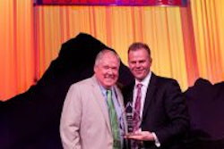 Floyd Merryman, president and CEO, Sonny Merryman accepting the Midwest Dealer of the Year Award from Caley Edgerly, president and CEO, Thomas Built Buses.
