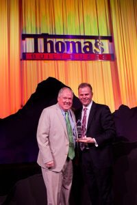 Floyd Merryman, president and CEO, Sonny Merryman accepting the Midwest Dealer of the Year Award from Caley Edgerly, president and CEO, Thomas Built Buses.