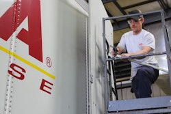 Technician making repairs to truck trailer.
