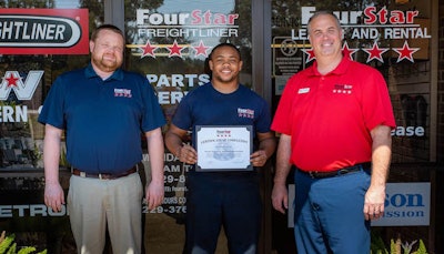 Marcellus Thornton (center) with Clay Lee, Albany service manager (left), and Scott Dixon, Four Star Freightliner operations manager.