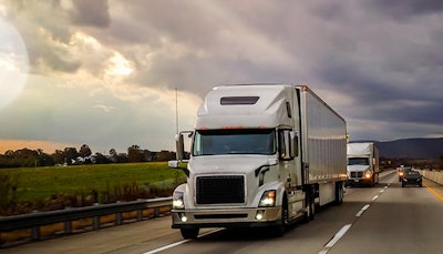 semi truck on the road with dark clouds