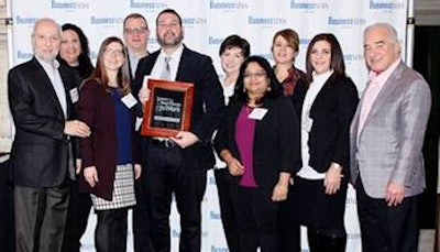 Shown celebrating at the awards ceremony with fellow employees are Joseph N. Evangelist, executive vice president (left); Sean Schnipper, marketing and social media manager (holding award); and Dennis M. Schneider, president (far right).