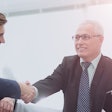 Stock-image-of-group-shaking-hands-700×400-min