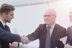 Stock-image-of-group-shaking-hands-700×400-min