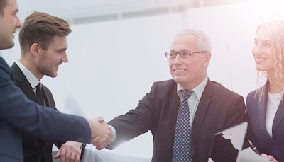 Stock-image-of-group-shaking-hands-700×400-min