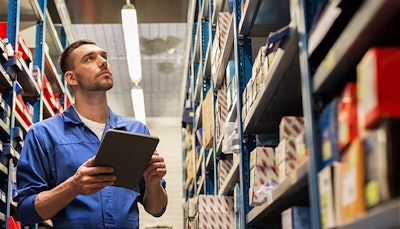 Employee checking stock in a parts department