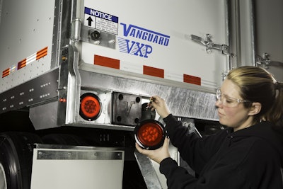 Technician installs an LED light from Optronics International.