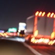 Truck on the road at night with lights on