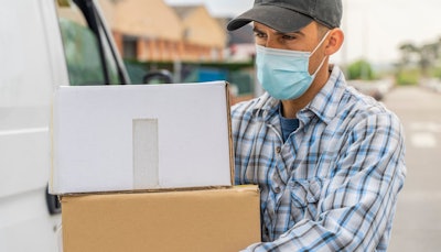 Delivery driver wearing mask due to COVID-19 coronavirus