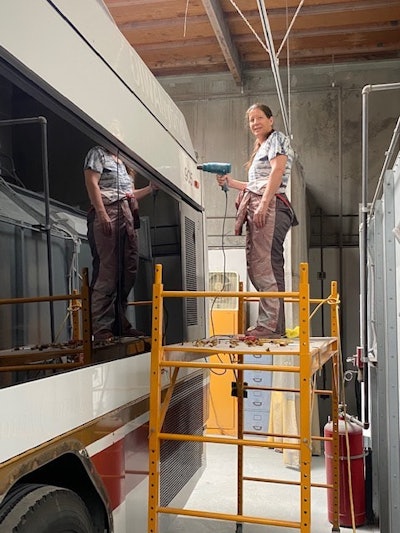 A technician works on a bus at Walker Autobody and Fleet Repair.
