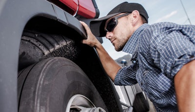 Technician inspecting truck for Mitchell 1 Tech Tips series