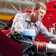 Peterbilt service technician works on engine