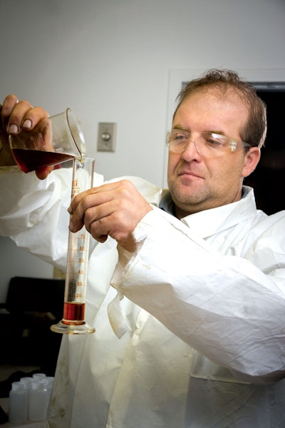 Kevin Adams, LSI Chemical vice president of research and development, tests a new LSI Chemical oil additive.