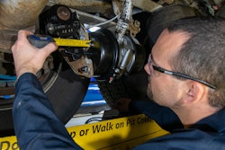 Bendix technician measures brake stroke in a wheel end