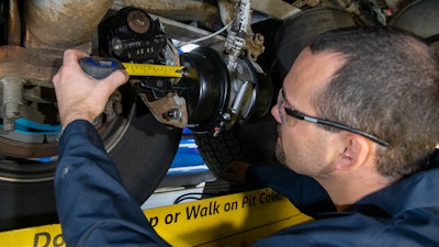 Bendix technician measures brake stroke in a wheel end