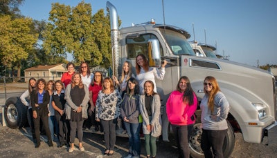 Women from Palmer Trucks’ Kenworth of Indianapolis – West facility stand in celebration alongside a new Kenworth T880. (Click to enlarge.)