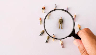 people figurines under a magnifying glass