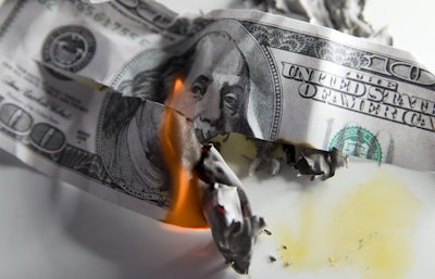 $100 bill in flames