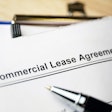 Commercial Lease Agreement form on a clipboard with a pen