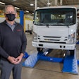 sean skinner, Isuzu Commercial Truck of Canada president, in front of Isuzu truck