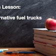 Today's Lesson: Alternative fuel trucks on a chalkboard behind a stack of books with an apple
