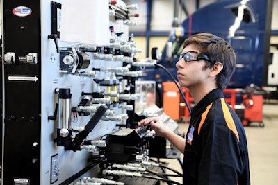 Duncan Polytechnical student technician controlling a machine