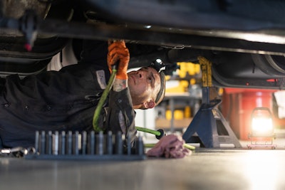 Navistar technician working under a truck
