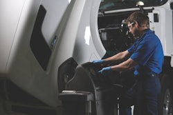 heavy duty truck technician examining a truck